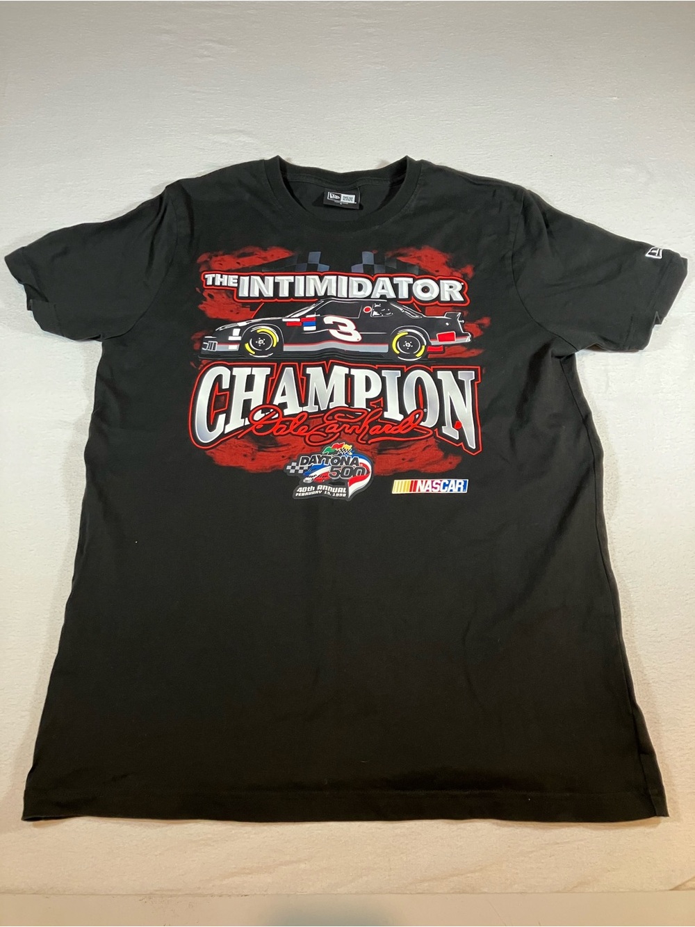 New Era Black 'The Intimidator' Champion Graphic Tee with Red and White Accents